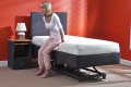 Low electric adjustable bed with vertical lift